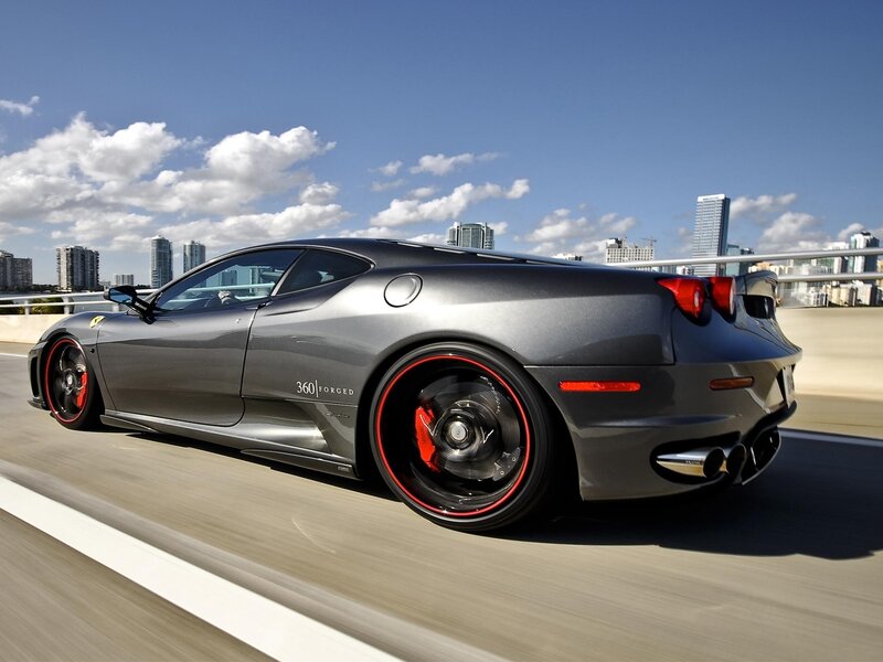 Gray Ferrari on city bridge
