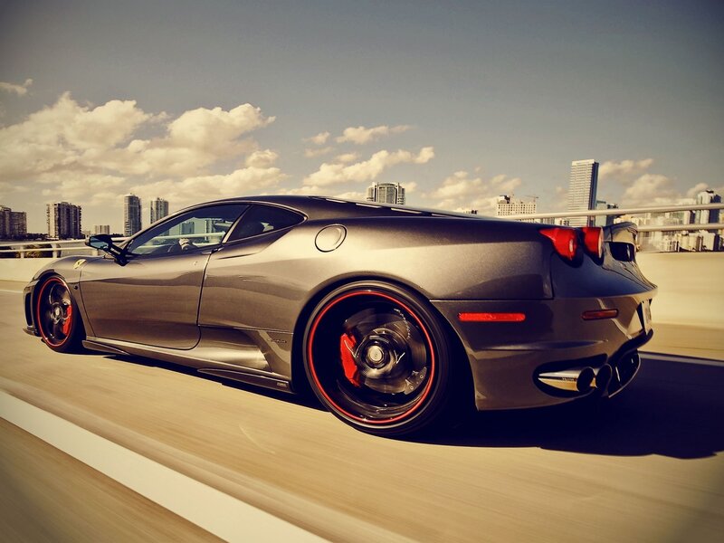 gray ferrari sports car in motion