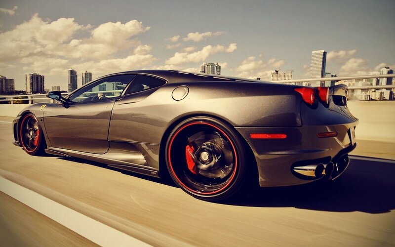 gray ferrari sports car on bridge