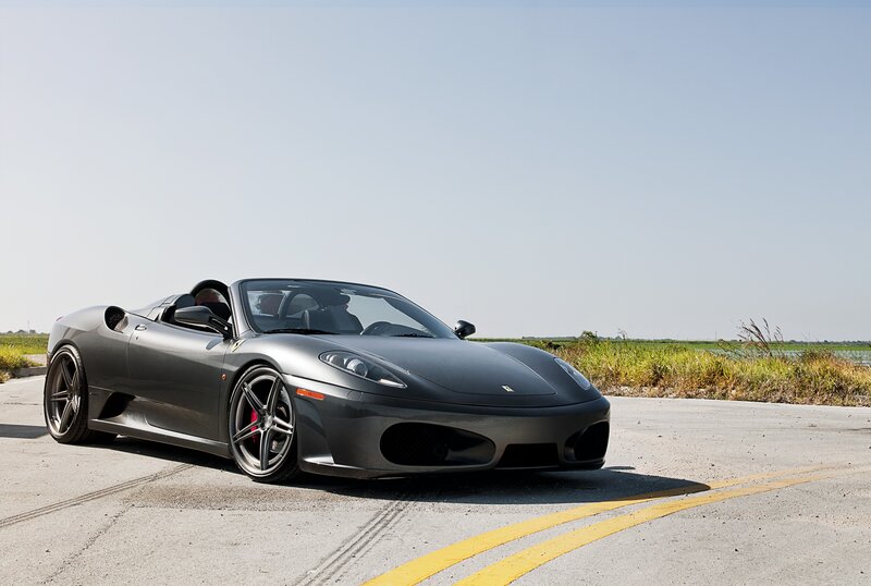 Gray Ferrari sports car on road