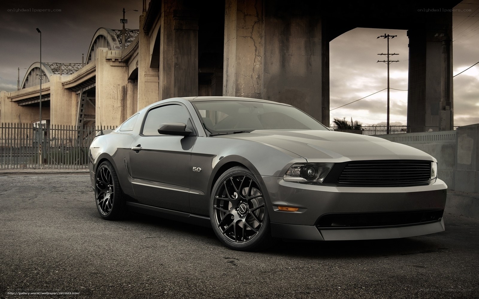Gray Ford Mustang under bridge