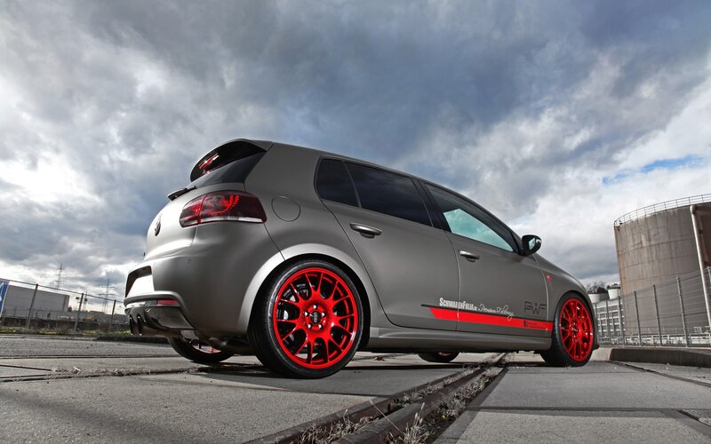 Gray Hatchback Car — Dramatic, Photograph, Red Wheels, Industrial Tanks