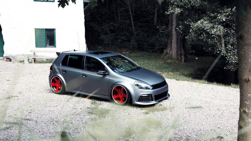 gray hatchback with red wheels