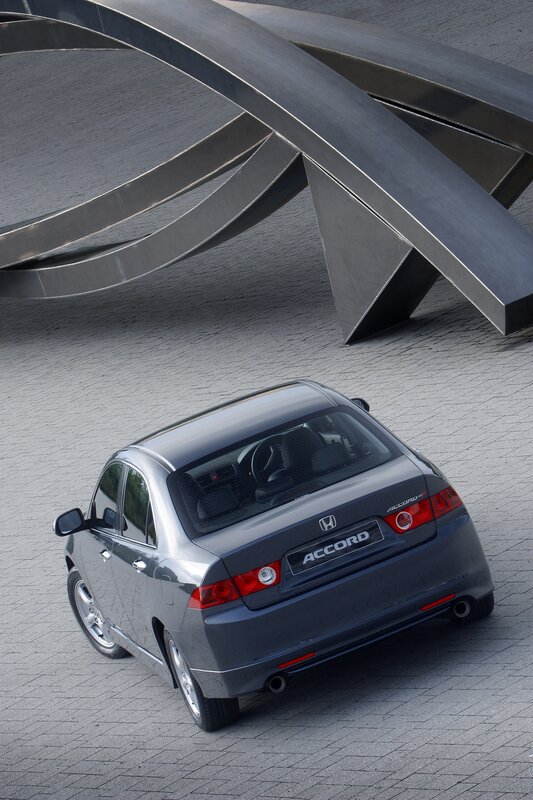 Gray Honda Accord parked under sculpture