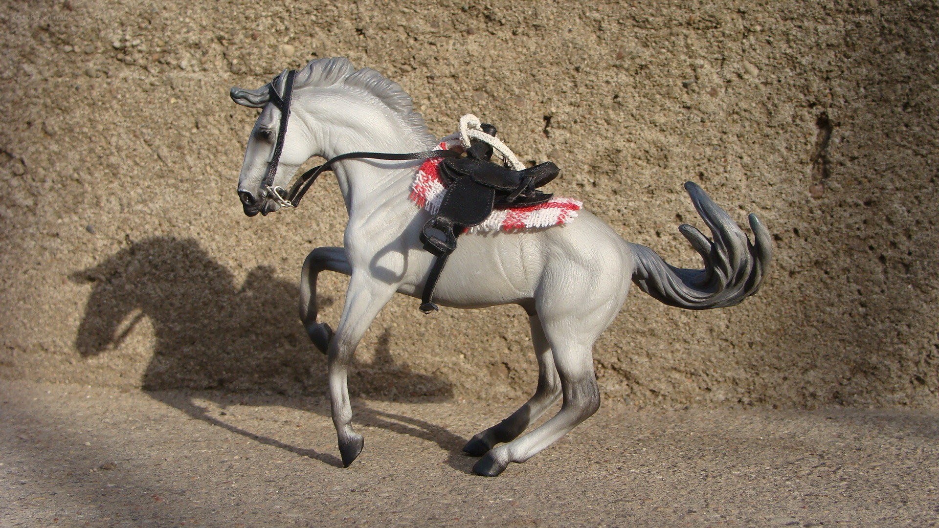gray horse figurine in motion