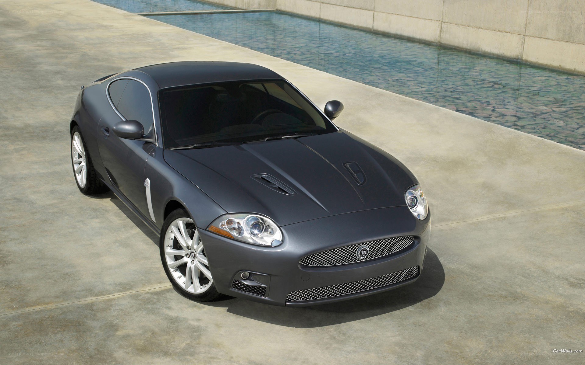 gray jaguar coupe by pool