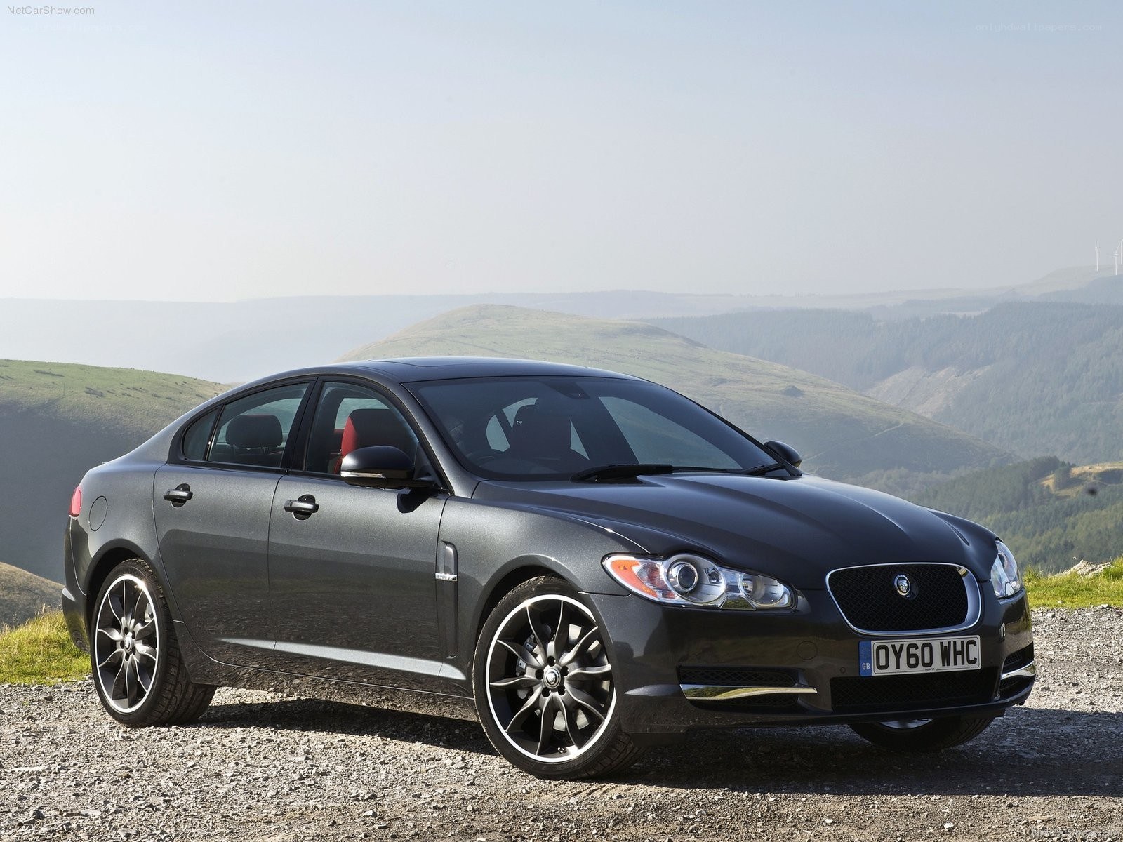 Gray Jaguar XF on a hillside