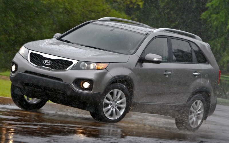 gray kia suv in rain