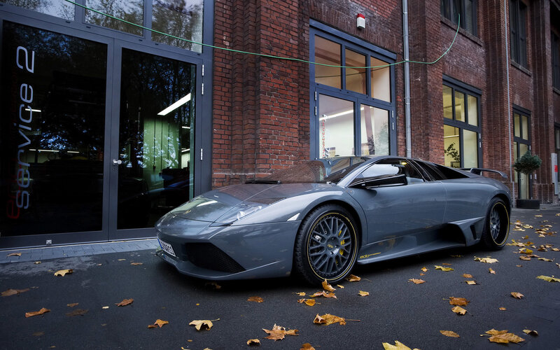 Gray Lamborghini in front of service building