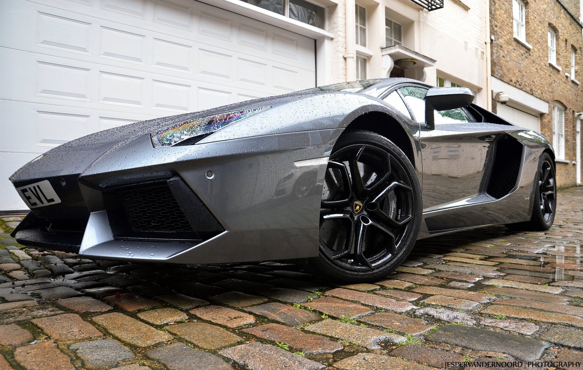 gray lamborghini on cobblestones