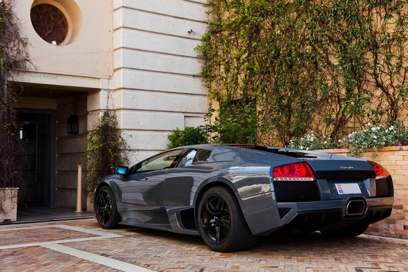 Gray Lamborghini parked outside building