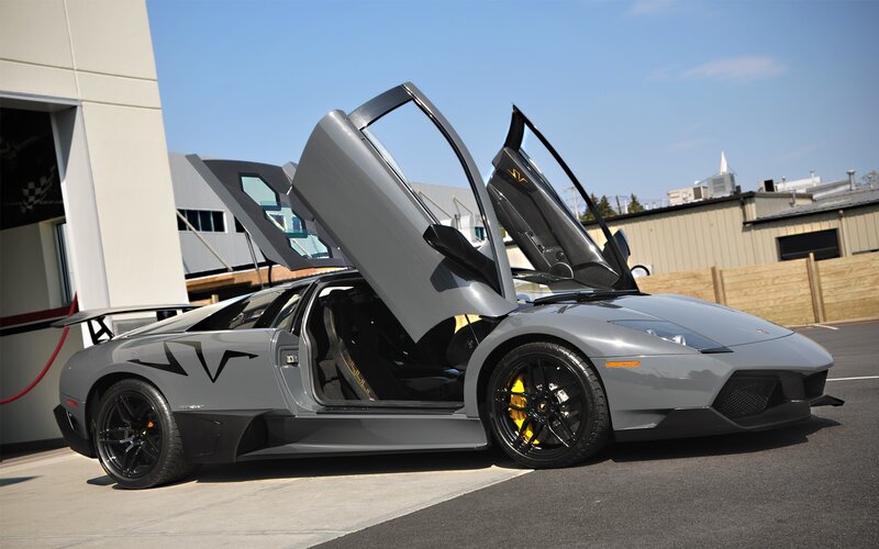 gray lamborghini with doors open
