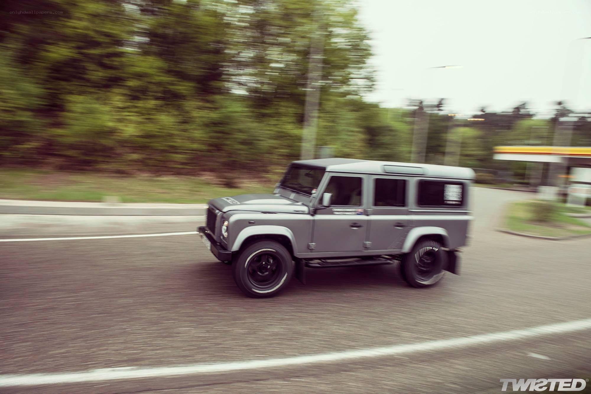 gray land rover driving on road