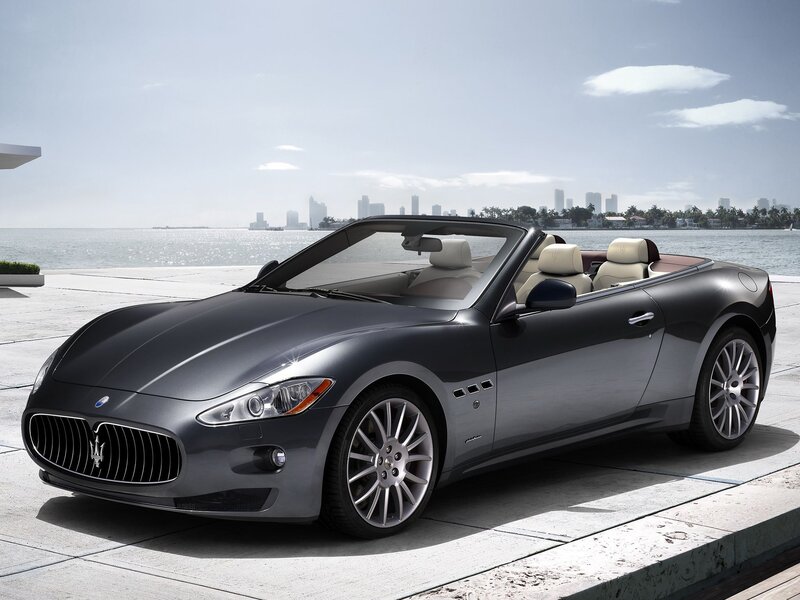 Gray Maserati convertible by the water