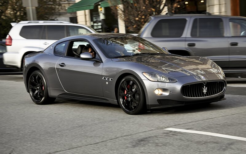 Gray Maserati driving on city street
