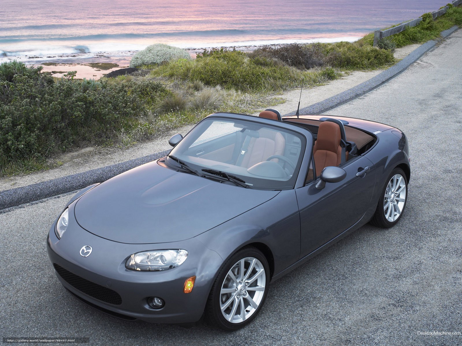 Gray Mazda Miata by the ocean