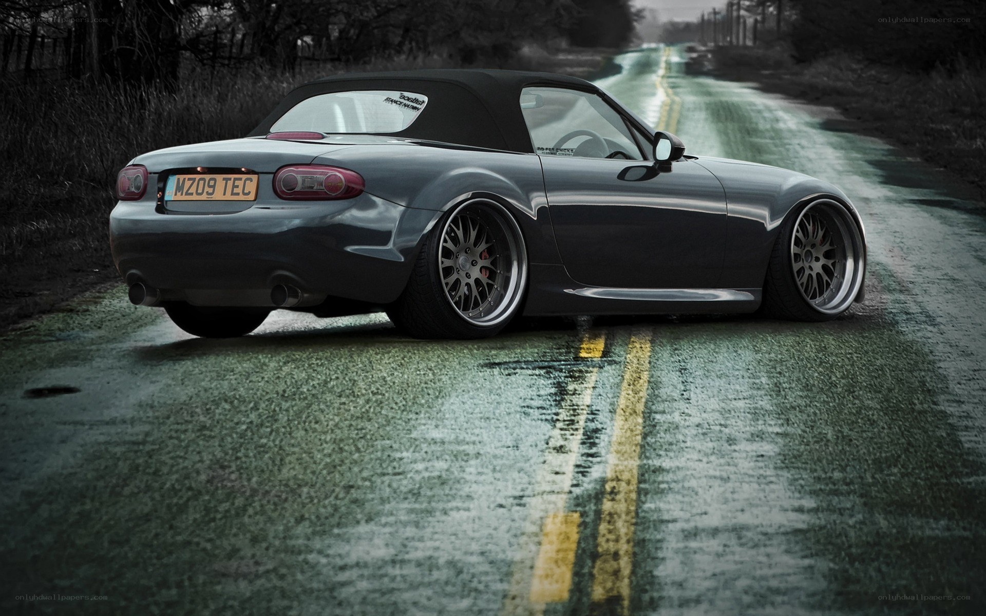 gray mazda miata on wet road