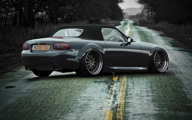 gray mazda miata on wet road