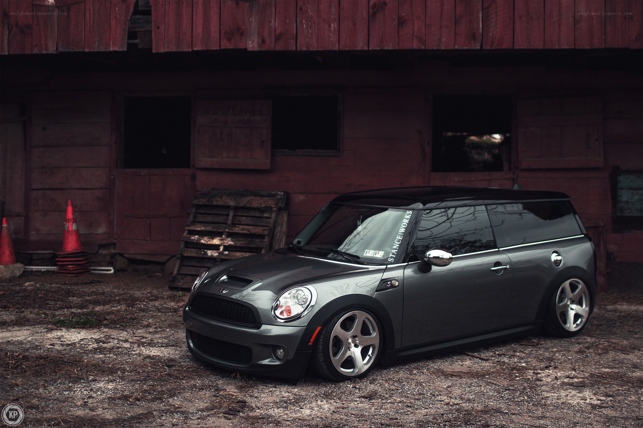 gray mini cooper in front of barn
