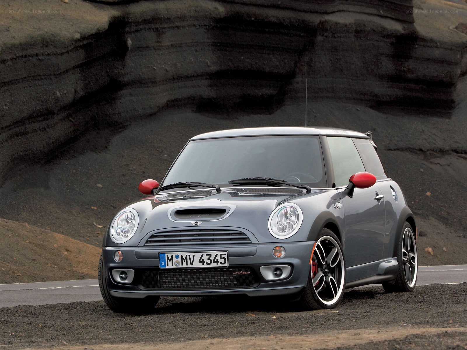 gray mini cooper on volcanic road