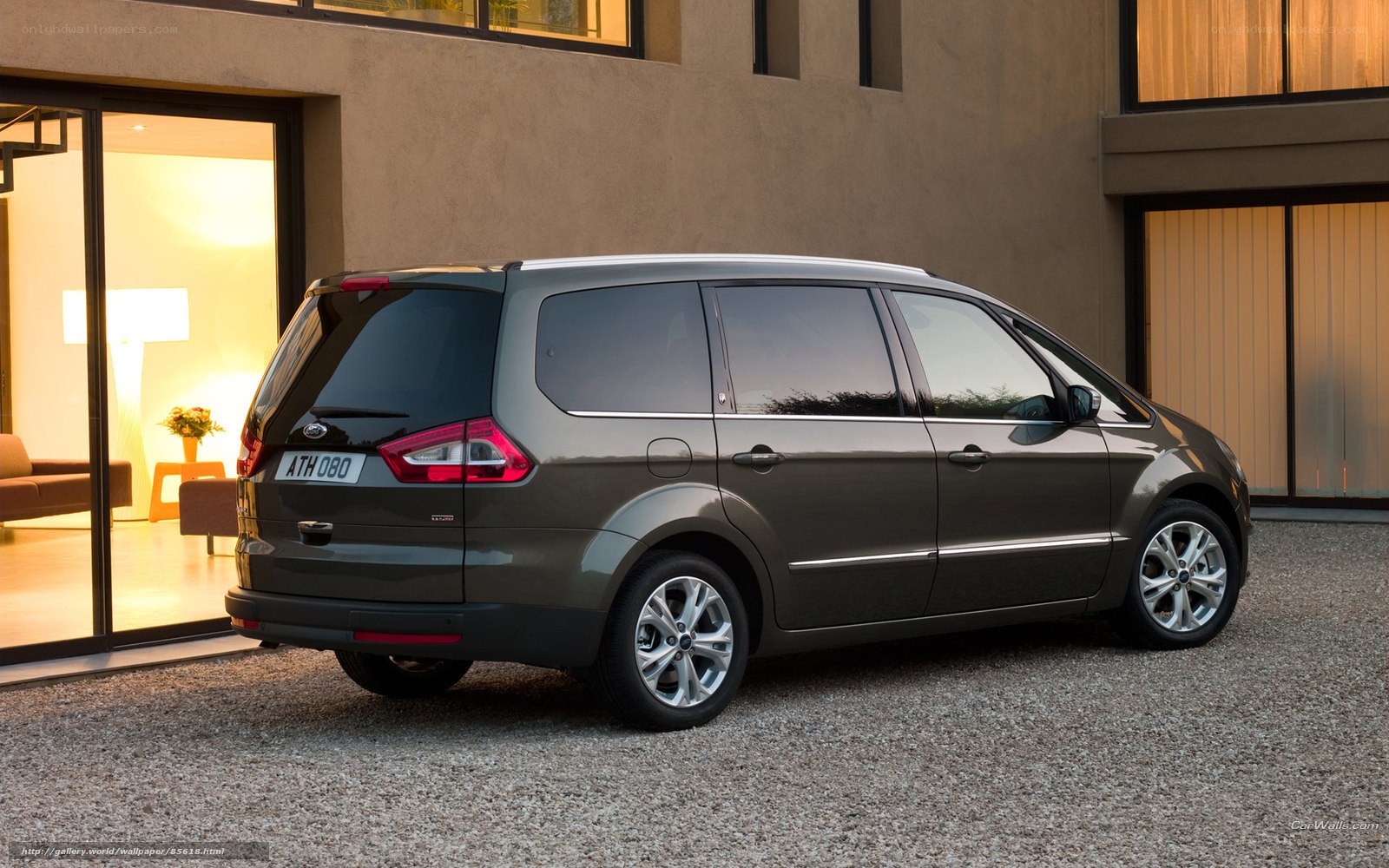 Gray minivan parked outside house