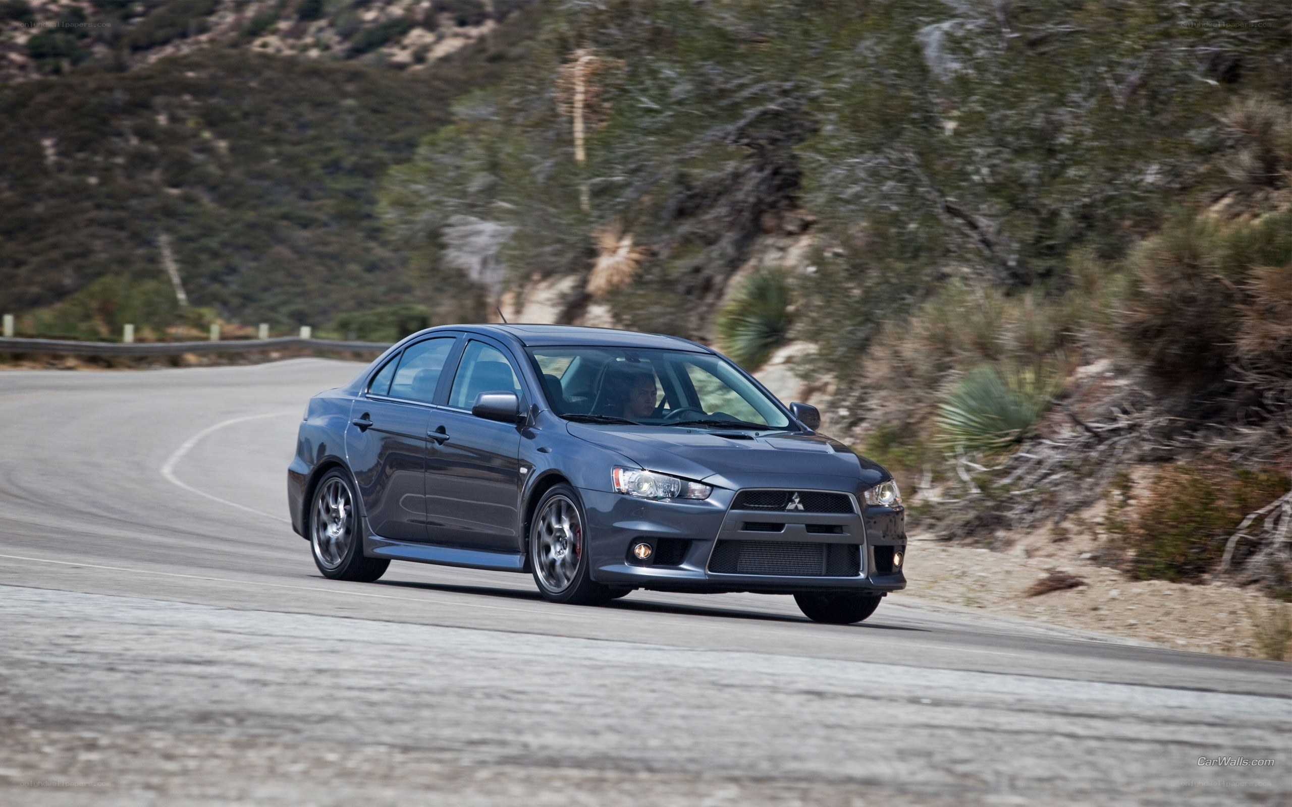 gray mitsubishi lancer driving on road
