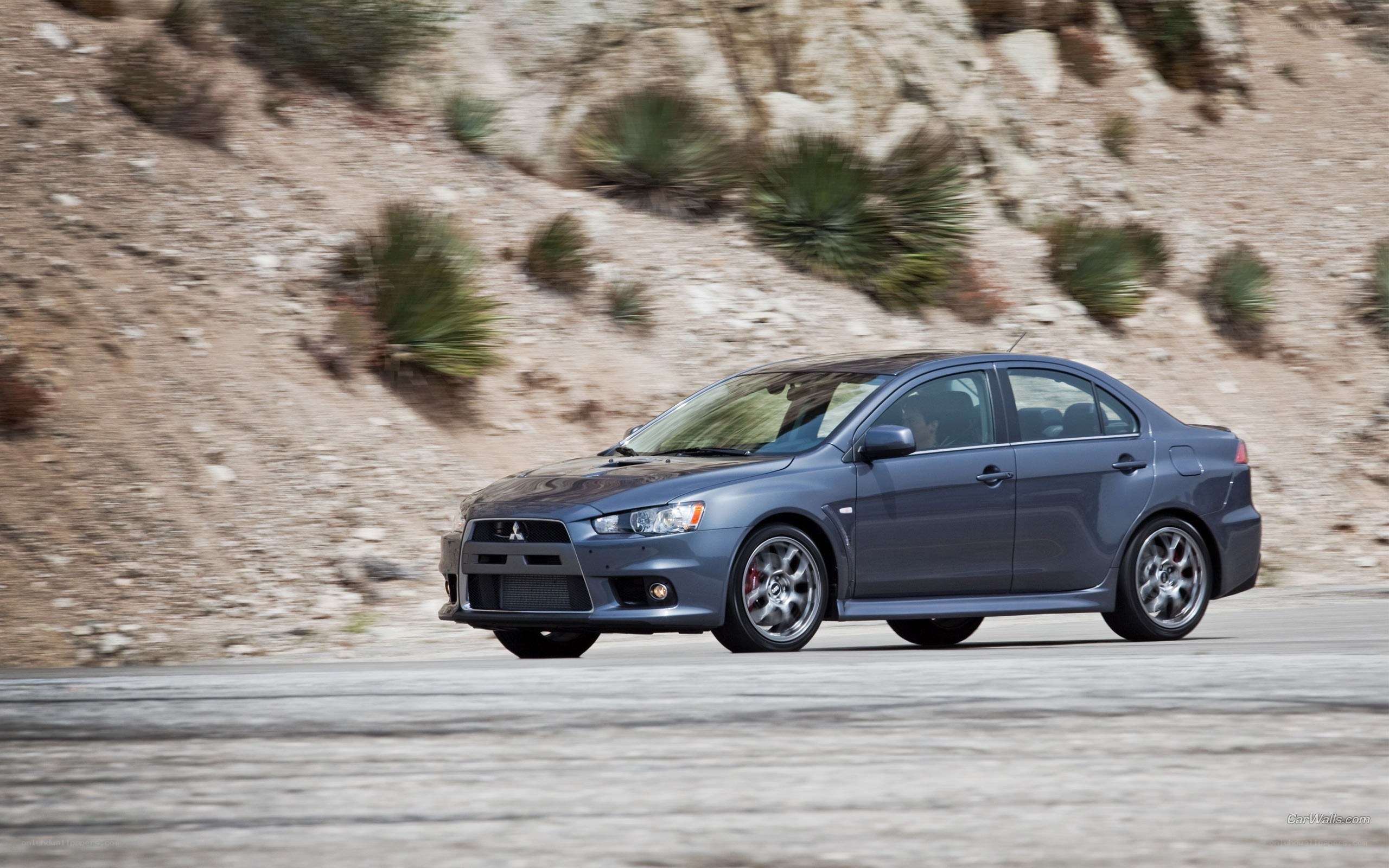 gray mitsubishi lancer in motion