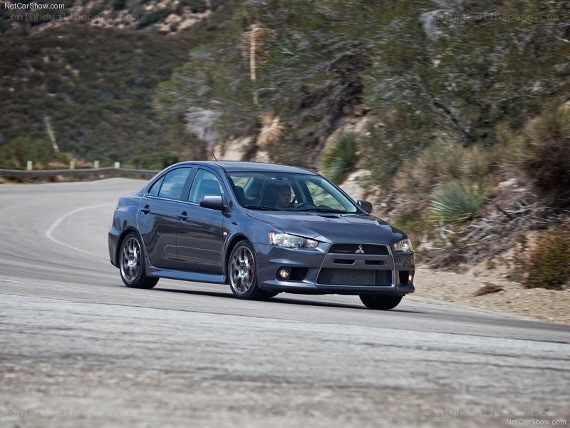 gray mitsubishi lancer on winding road