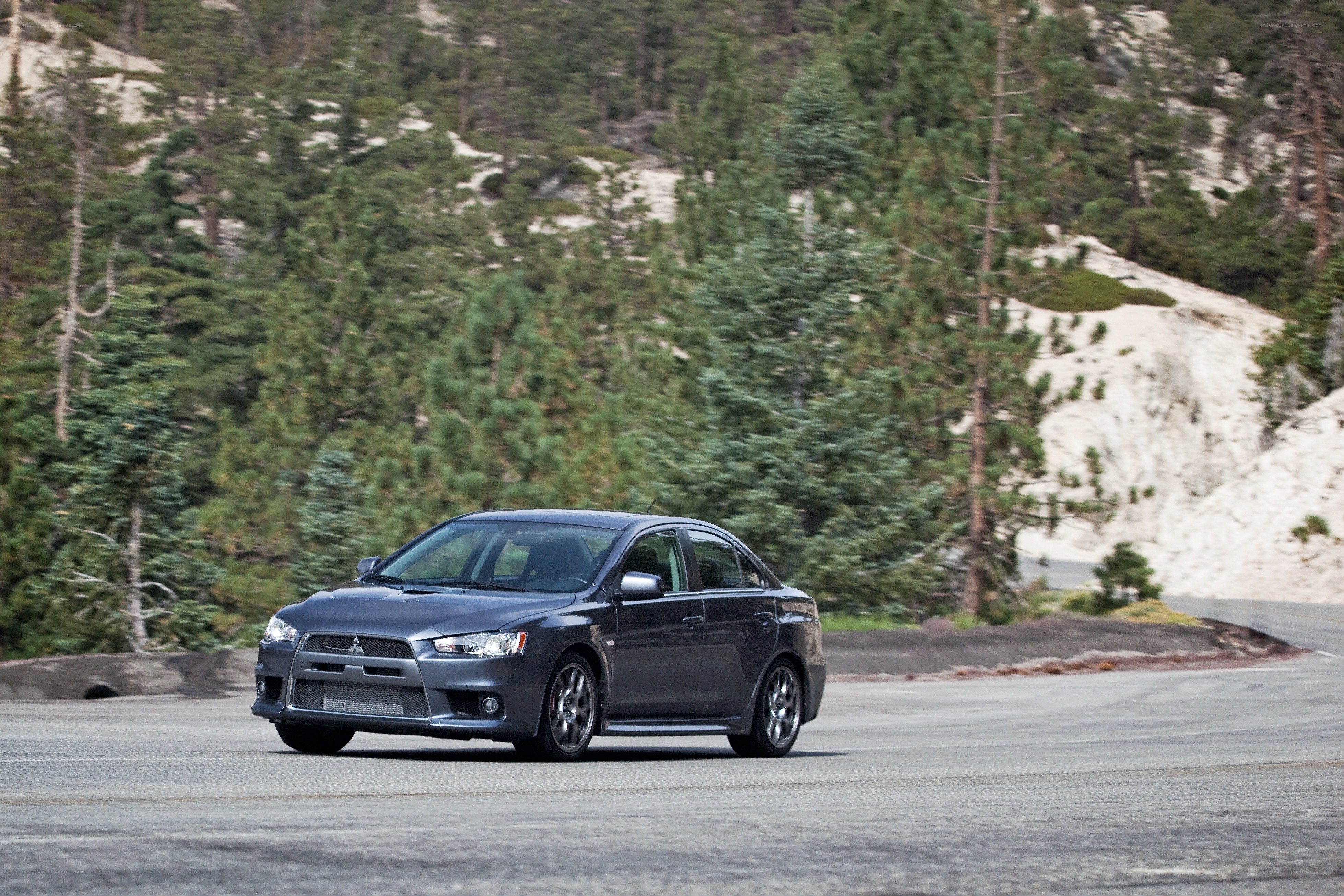 gray mitsubishi on mountain road