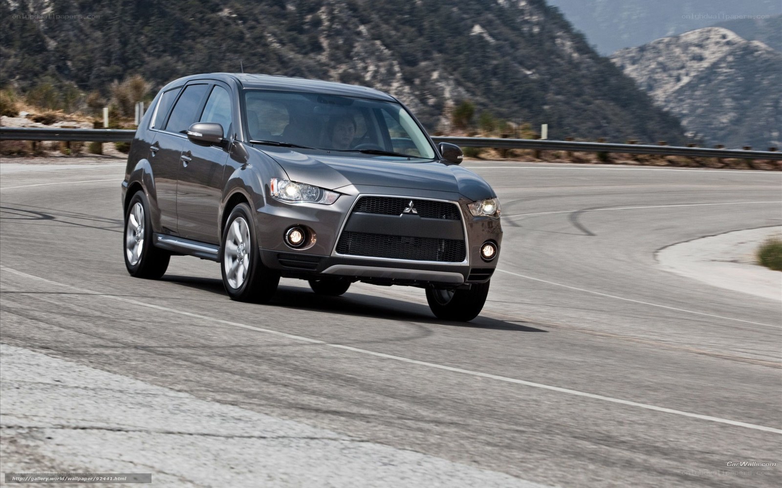 gray mitsubishi suv on winding road