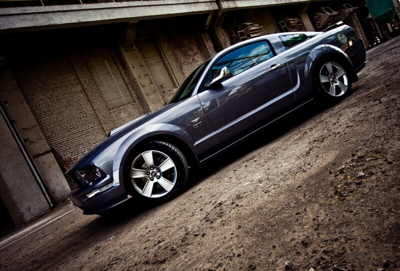 gray mustang on dirt road