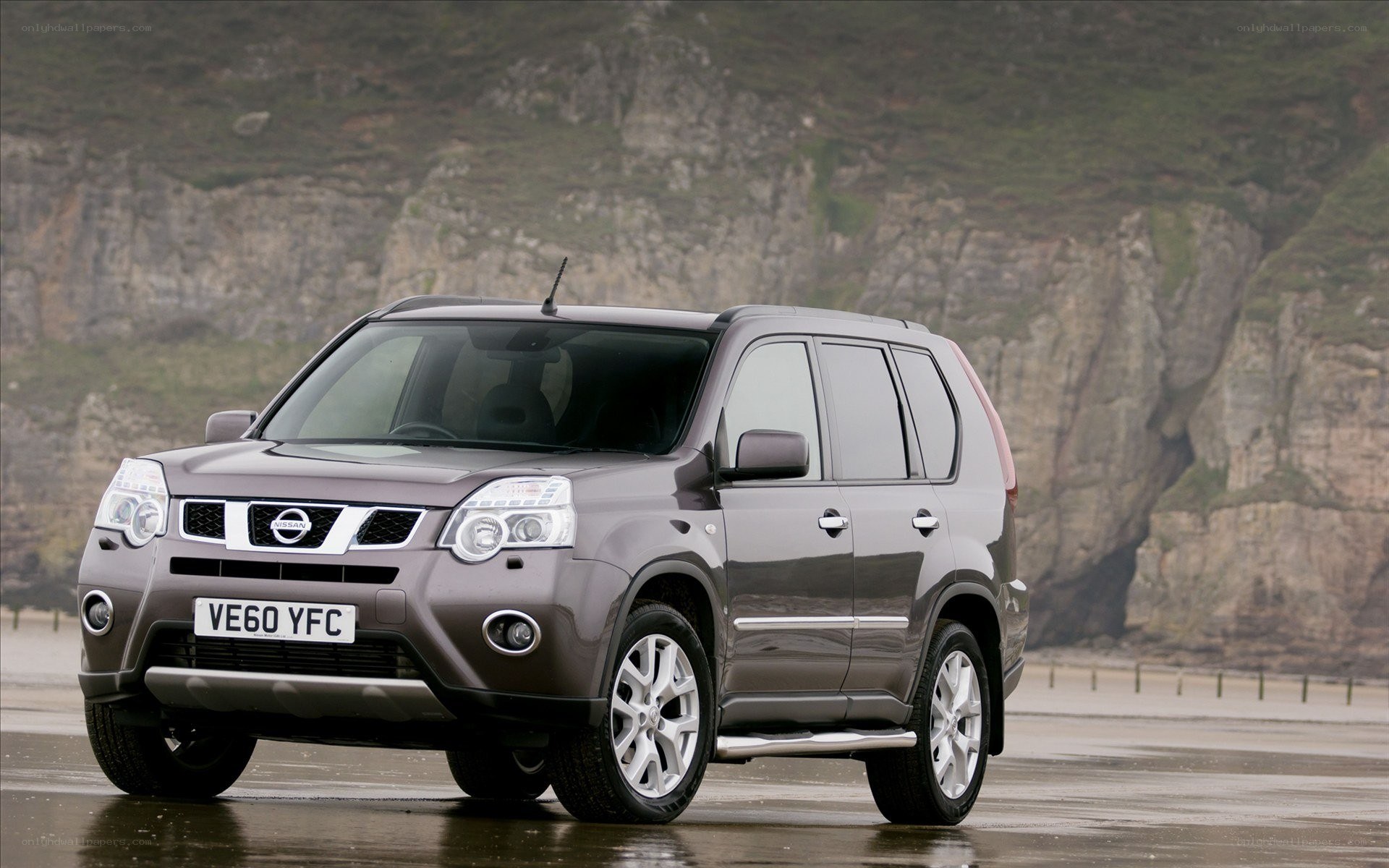 Gray Nissan X-Trail on beach