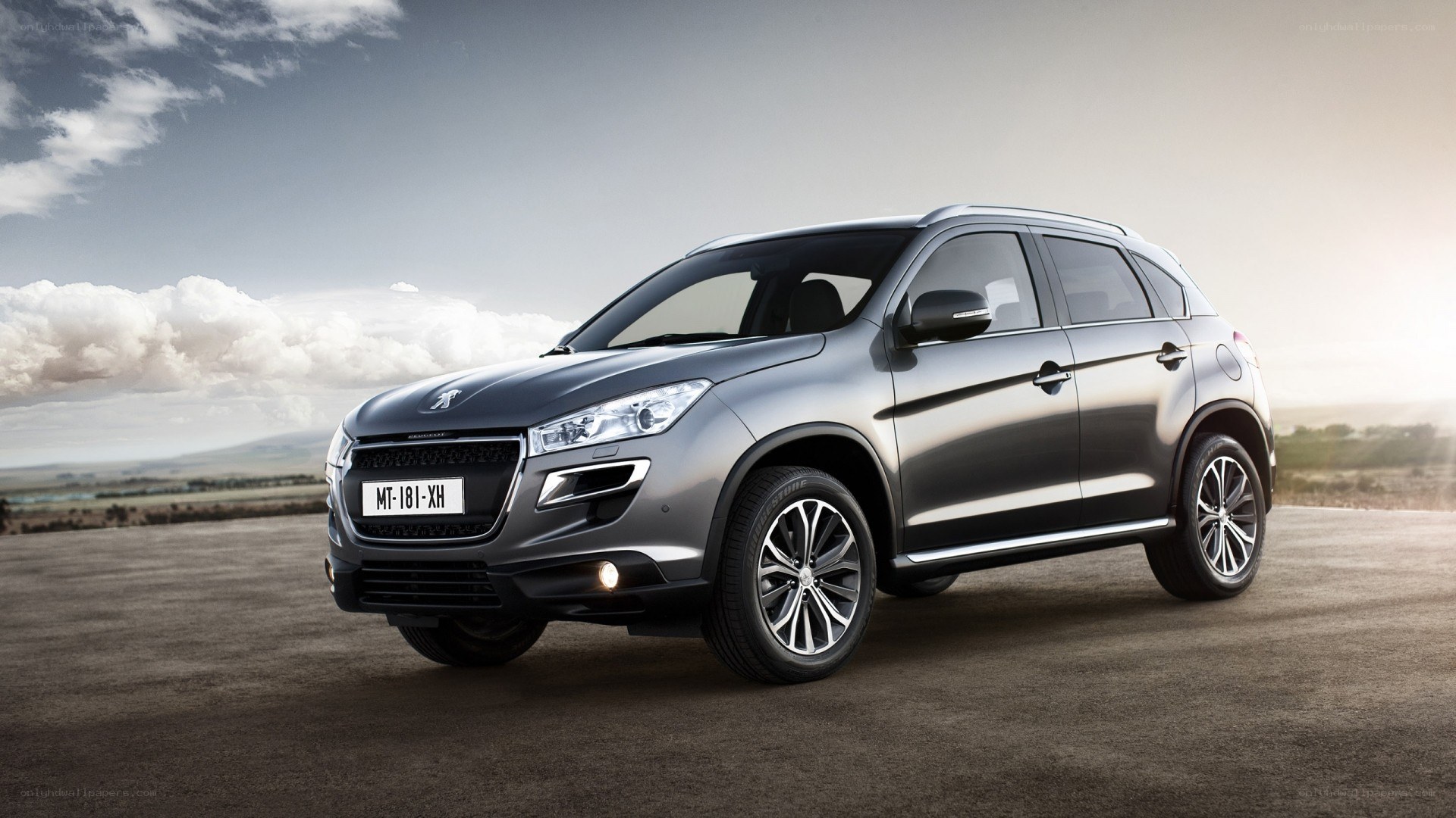 Gray Peugeot SUV on open road