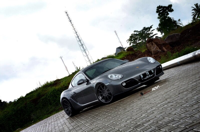 Gray Porsche Cayman on a paved road