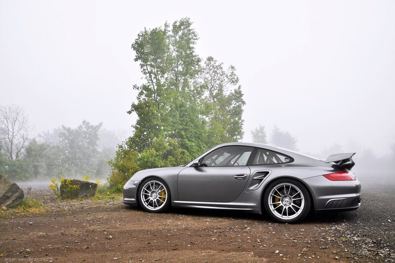 Gray Porsche in foggy landscape