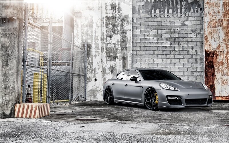 gray porsche in industrial alley
