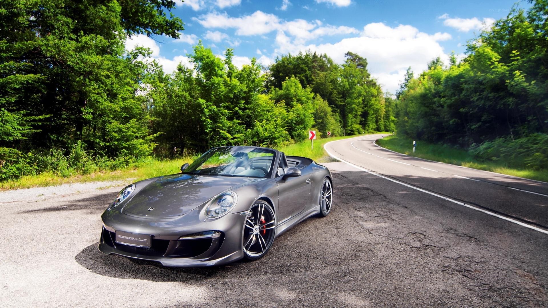 Gray Porsche on a winding road