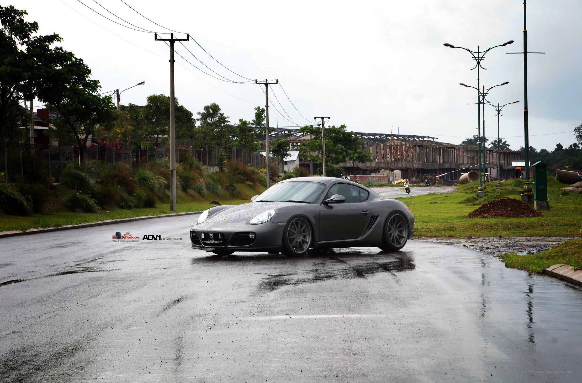 gray porsche on wet road