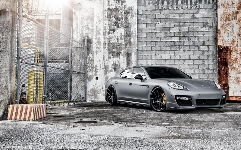 gray porsche parked in alley