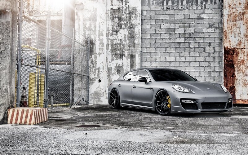 gray porsche parked in alley