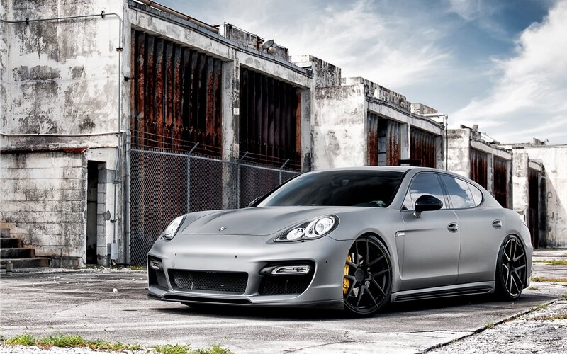 gray porsche parked in industrial lot