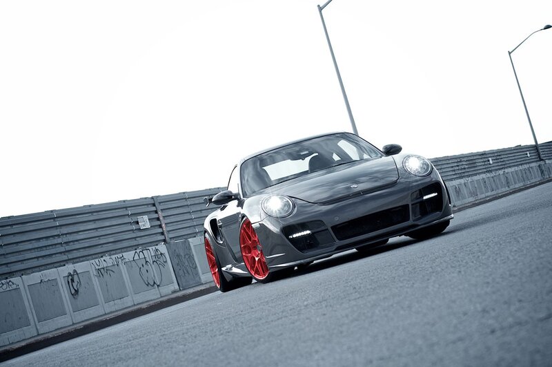 gray porsche with red wheels