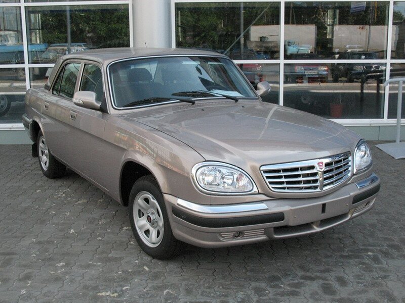gray sedan car in front of building