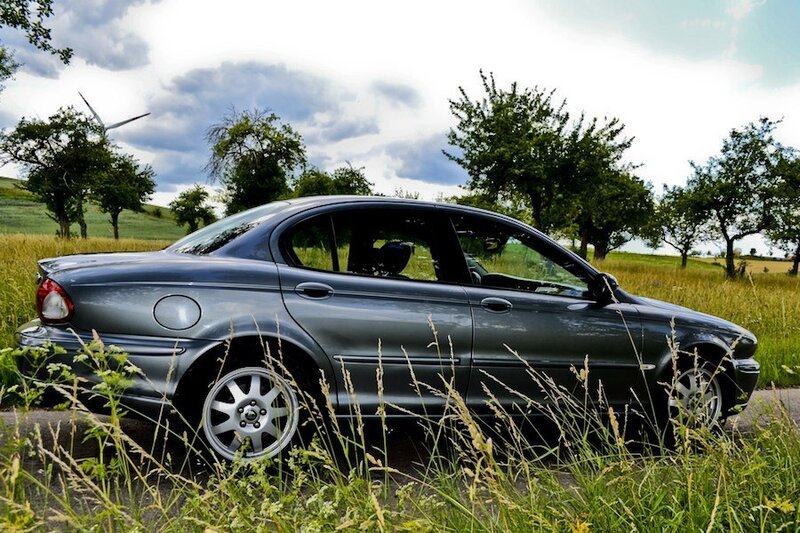 Gray sedan in a field