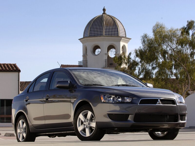Gray sedan in front of dome building