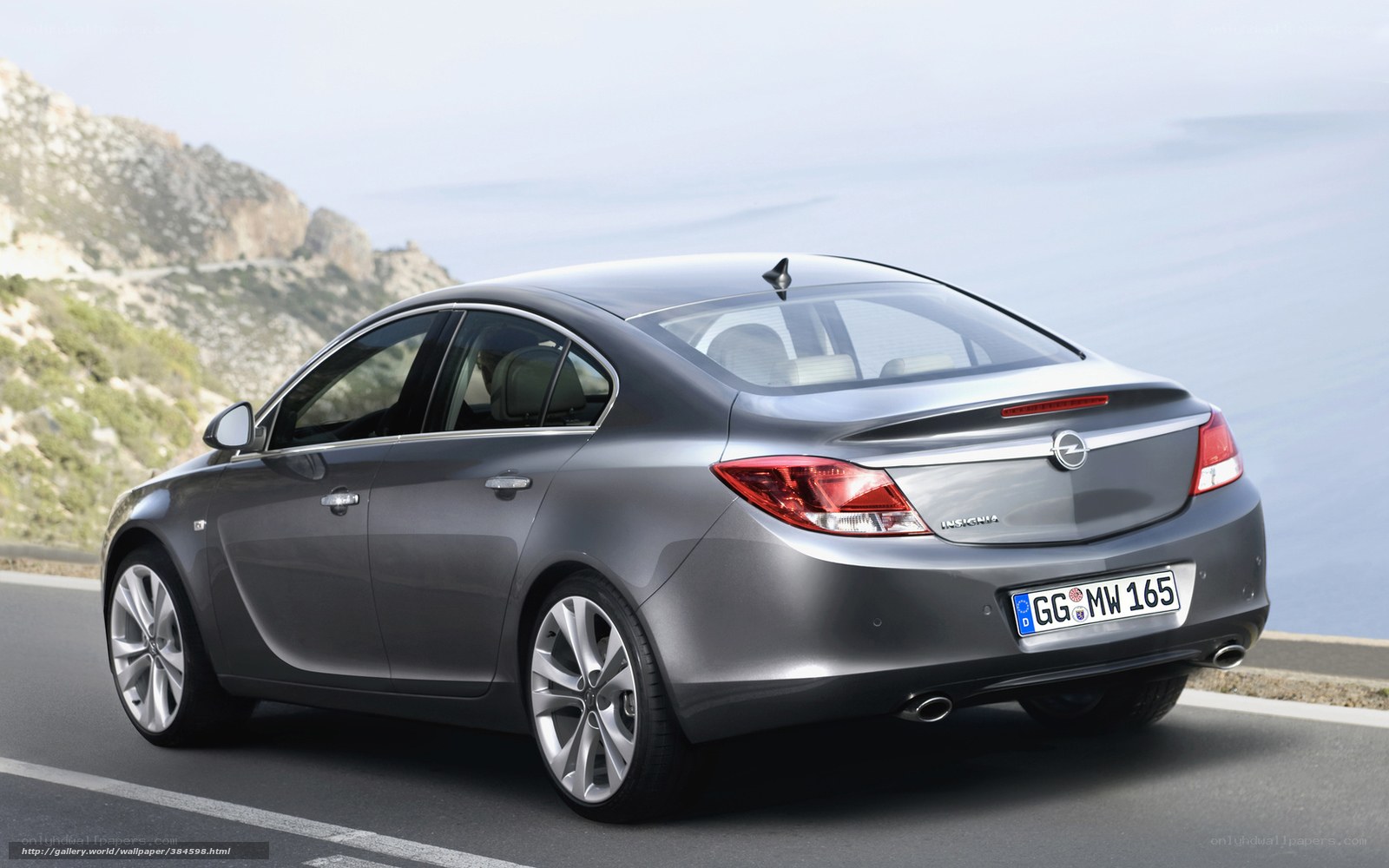 Gray sedan on coastal road