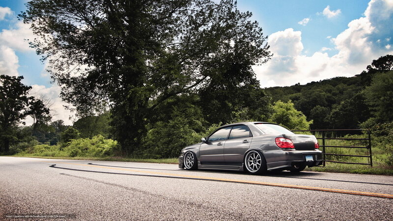 gray sedan on country road
