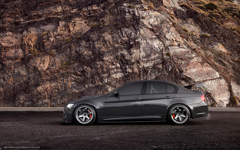 gray sedan on rocky road