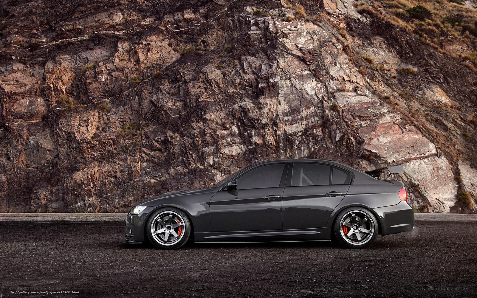 gray sedan on rocky road