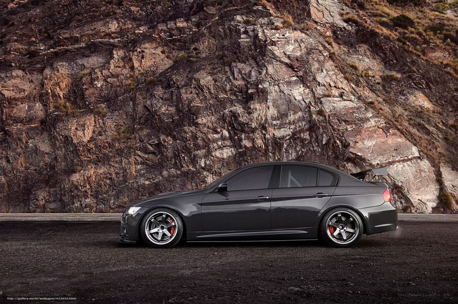 gray sedan on rocky road